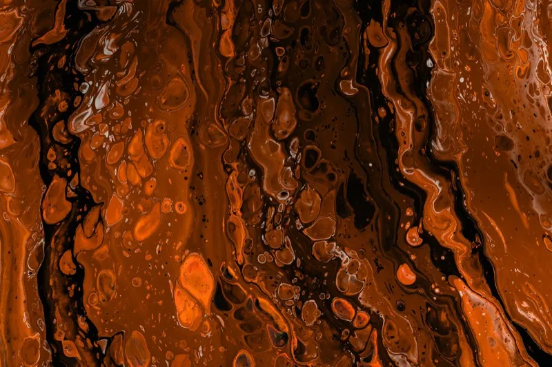 Dark abstract fluid art texture in deep black with copper and amber swirls
